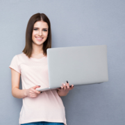 Inside_Header_GirlStandingWithComputer.png